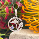 Silver Circular Silver Bird of paradise tanzanite pendant