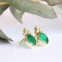 Sublime Bezel Set Oval Cut Emerald and Trilogy Diamond Earrings In Yellow Gold
