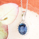 Oval Sapphire and Diamond Halo Pendant in white Gold