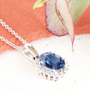 Oval Sapphire and Diamond Halo Pendant in white Gold