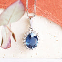 Oval Sapphire and Diamond Halo Pendant in white Gold