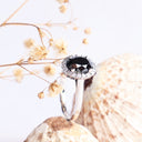 Oval Cut Black diamond ring with white diamond halo