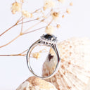 Oval Cut Black diamond ring with white diamond halo