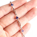 Trilliant Cut Tanzanite And White Gold Loop Bracelet
