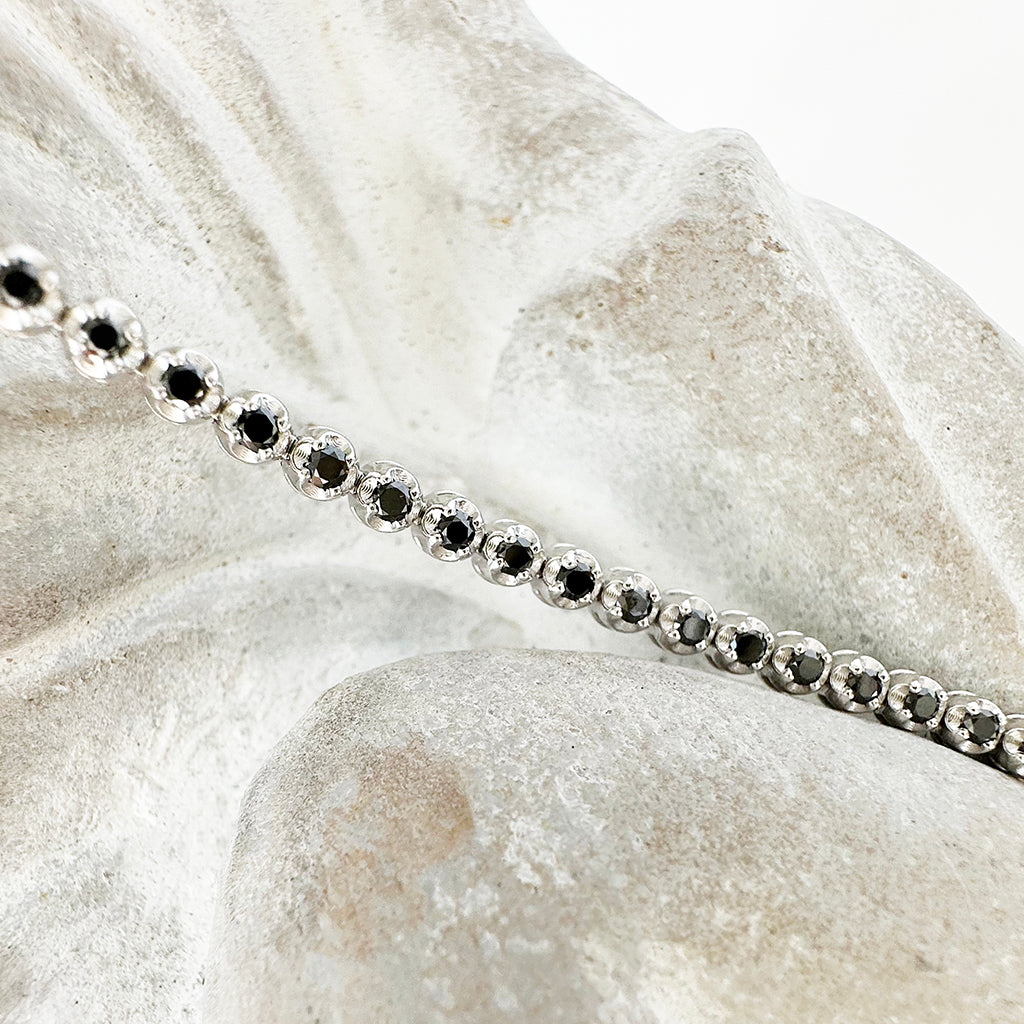 Whimsical White Gold Four Claw Encased Black Diamond Bracelet