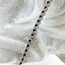 Whimsical White Gold Four Claw Encased Black Diamond Bracelet