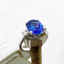 Elevated Four Claw Oval Cut Tanzanite and Diamond Highlight White Gold Ring