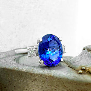 Elevated Four Claw Oval Cut Tanzanite and Diamond Highlight White Gold Ring