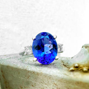 Elevated Four Claw Oval Cut Tanzanite and Diamond Highlight White Gold Ring