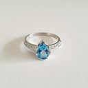 Pear Cut Blue Topaz White Gold Ring with Diamond Band Accent