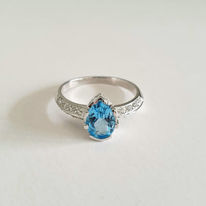 Pear Cut Blue Topaz White Gold Ring with Diamond Band Accent
