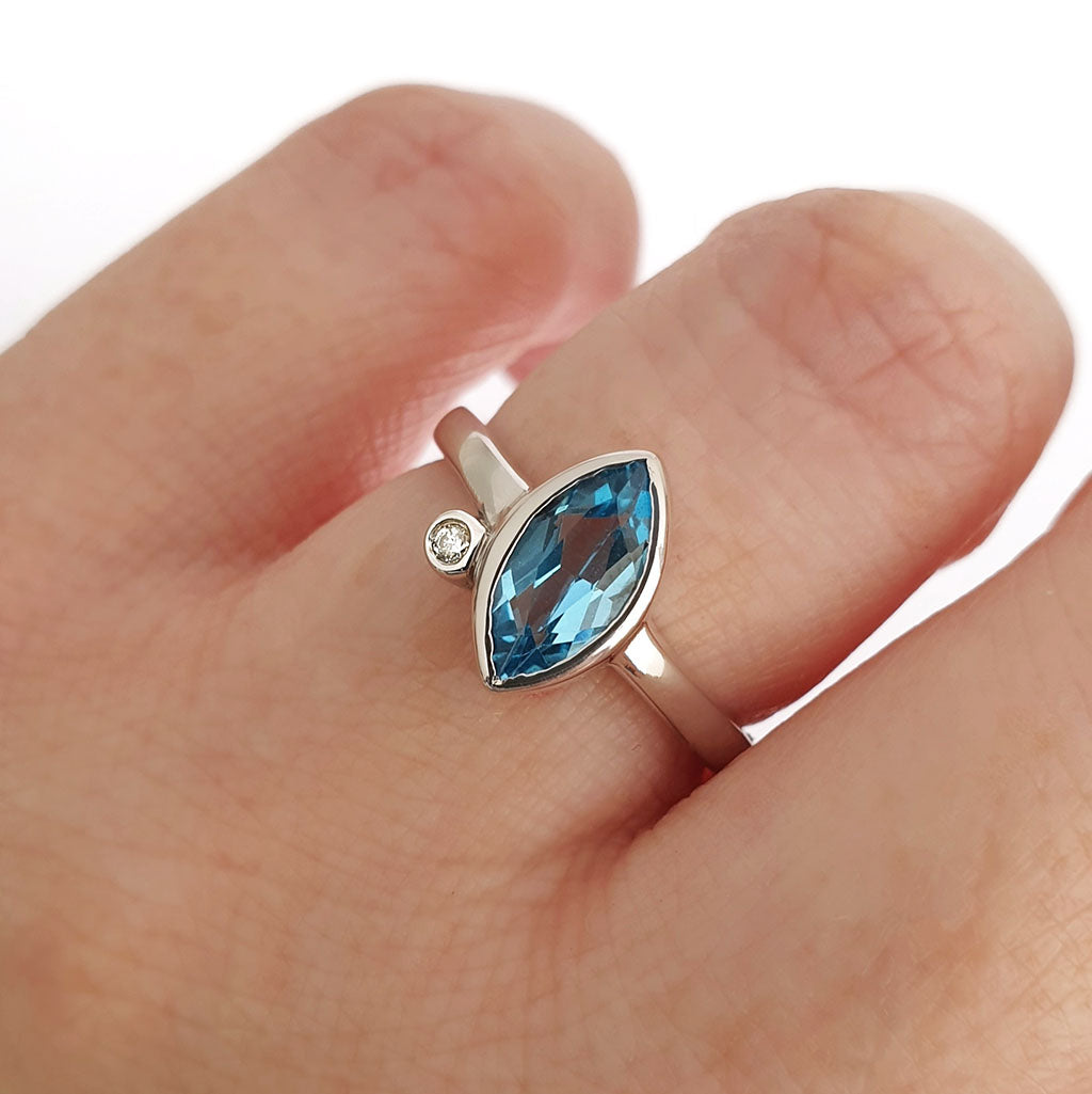 Bezel Set Marquise Cut Blue Topaz And Diamond Ring