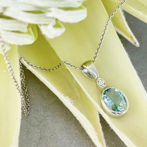 Charming Oval Bezel Set Aquamarine and Diamond Pendant