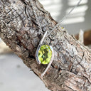Dynamic White Gold Twisted Oval Cut Peridot Pendant