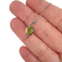 Dynamic White Gold Twisted Oval Cut Peridot Pendant