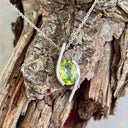 Dynamic White Gold Twisted Oval Cut Peridot Pendant