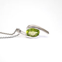 Dynamic White Gold Twisted Oval Cut Peridot Pendant