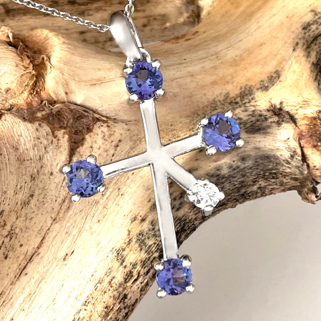 A tanzanite and diamond cross pendant, set with an oval … | Drouot.com