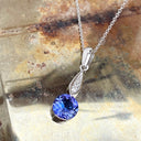 Elegant Round Tanzanite with Diamond Droplet Pendant