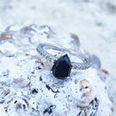 Elegant pear cut black diamond with diamond shoulder accented ring