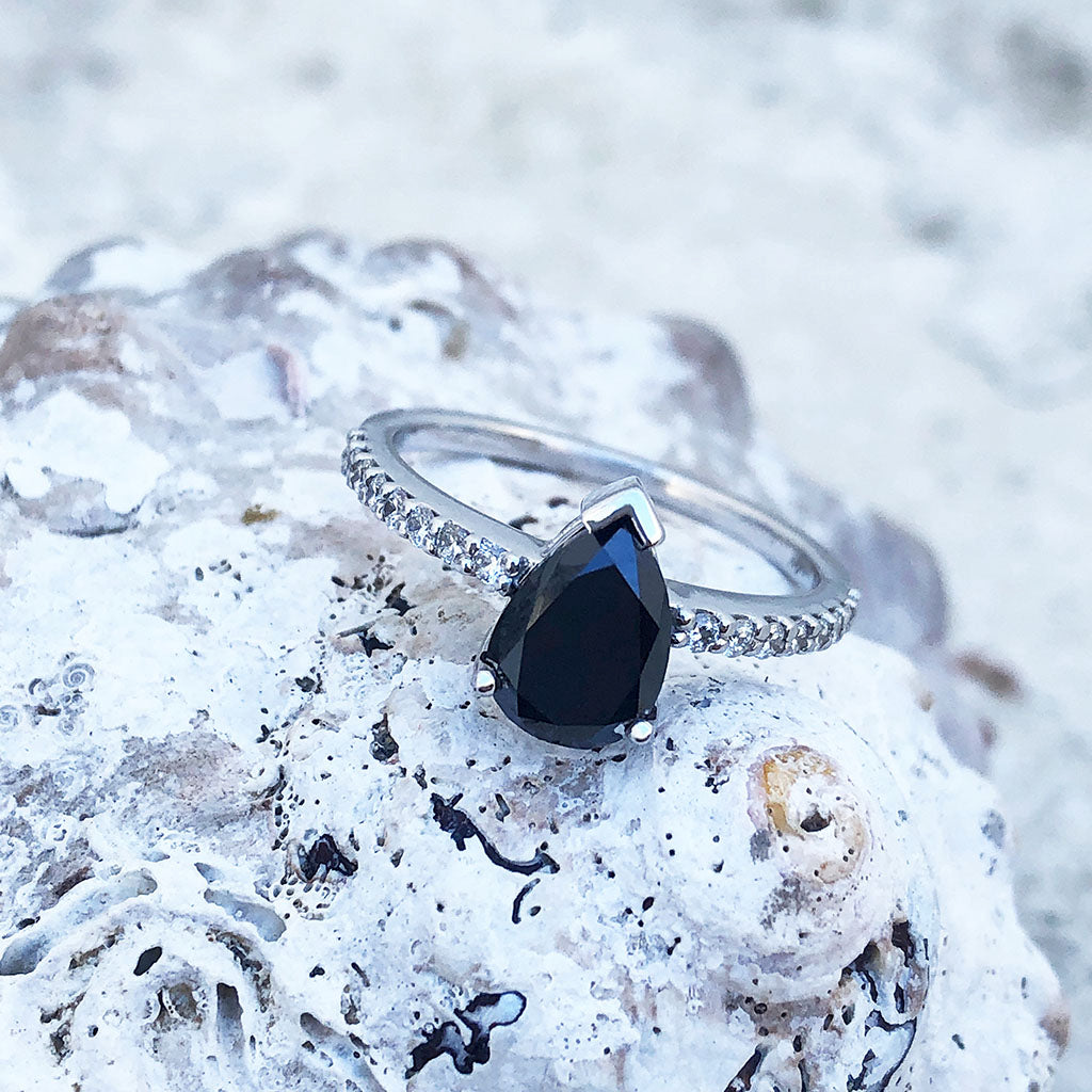 Elegant pear cut black diamond with diamond shoulder accented ring