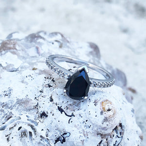 Elegant pear cut black diamond with diamond shoulder accented ring