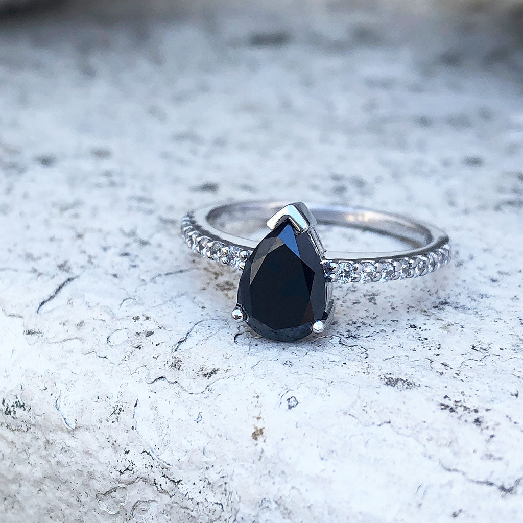 Elegant pear cut black diamond with diamond shoulder accented ring