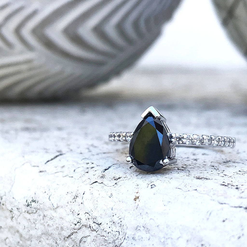 Elegant pear cut black diamond with diamond shoulder accented ring