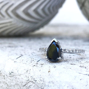 Elegant pear cut black diamond with diamond shoulder accented ring