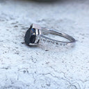 Elegant pear cut black diamond with diamond shoulder accented ring