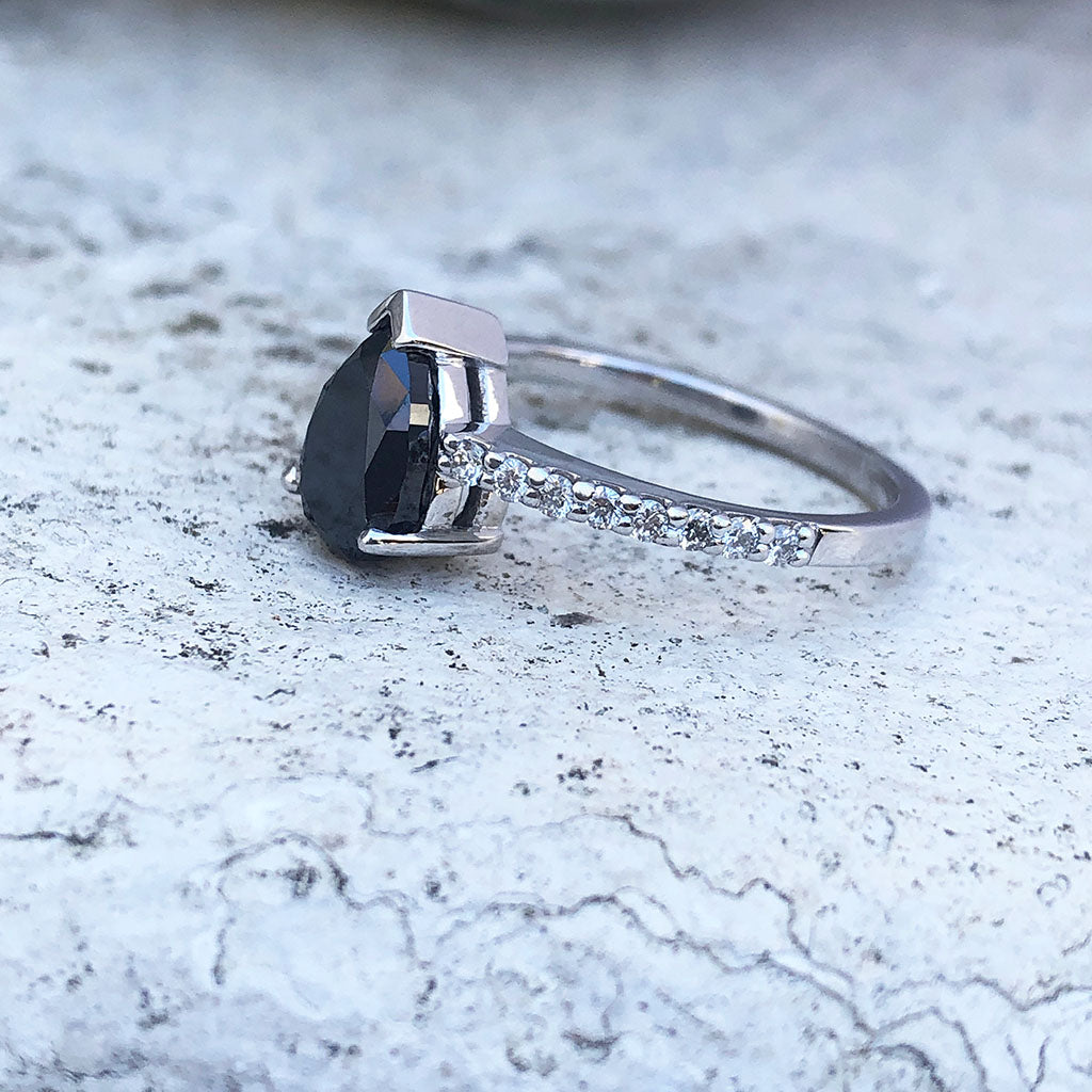 Elegant pear cut black diamond with diamond shoulder accented ring