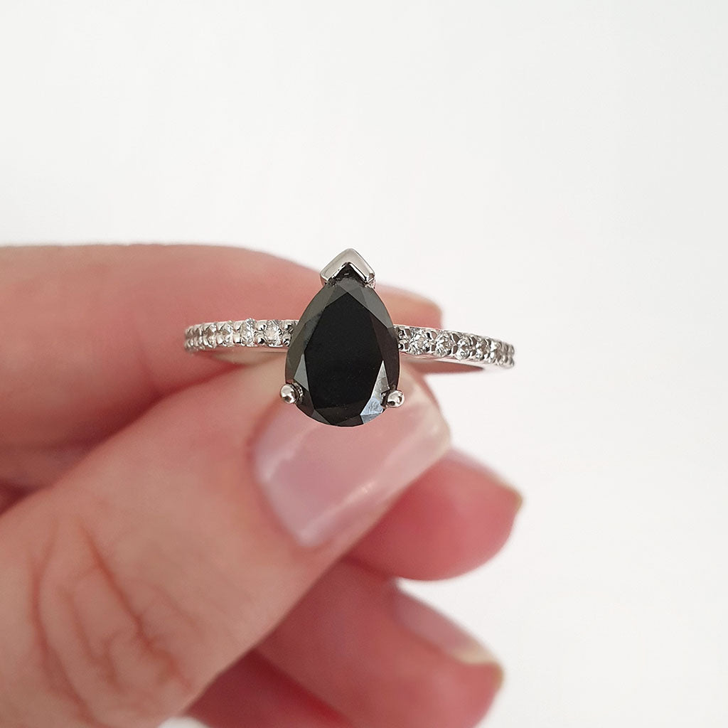 Elegant pear cut black diamond with diamond shoulder accented ring
