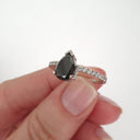 Elegant pear cut black diamond with diamond shoulder accented ring