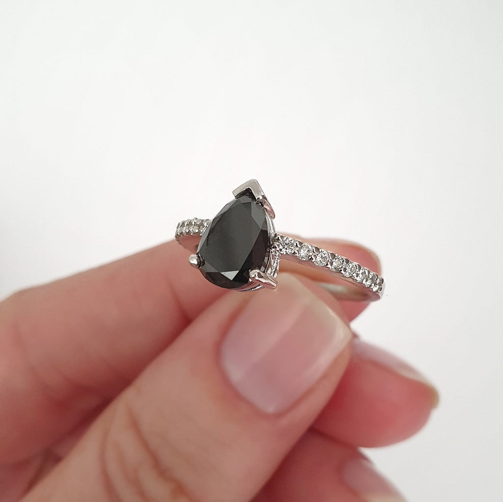 Elegant pear cut black diamond with diamond shoulder accented ring