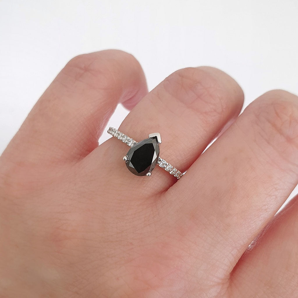 Elegant pear cut black diamond with diamond shoulder accented ring