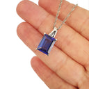 Emerald Cut Tanzanite with Swish Detailed Fixed Bale pendant