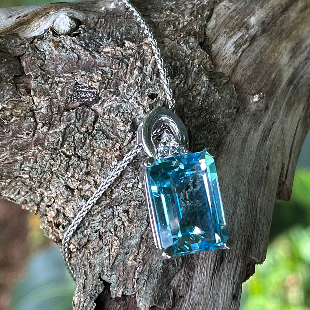 Handmade Emerald Cut Blue Topaz Pendant With Trilogy Diamond Accent