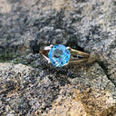 Solitaitre Round Cut and Claw Blue Topaz Yellow Gold Ring