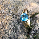 Solitaitre Round Cut and Claw Blue Topaz Yellow Gold Ring