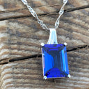 Emerald Cut Tanzanite with Swish Detailed Fixed Bale pendant