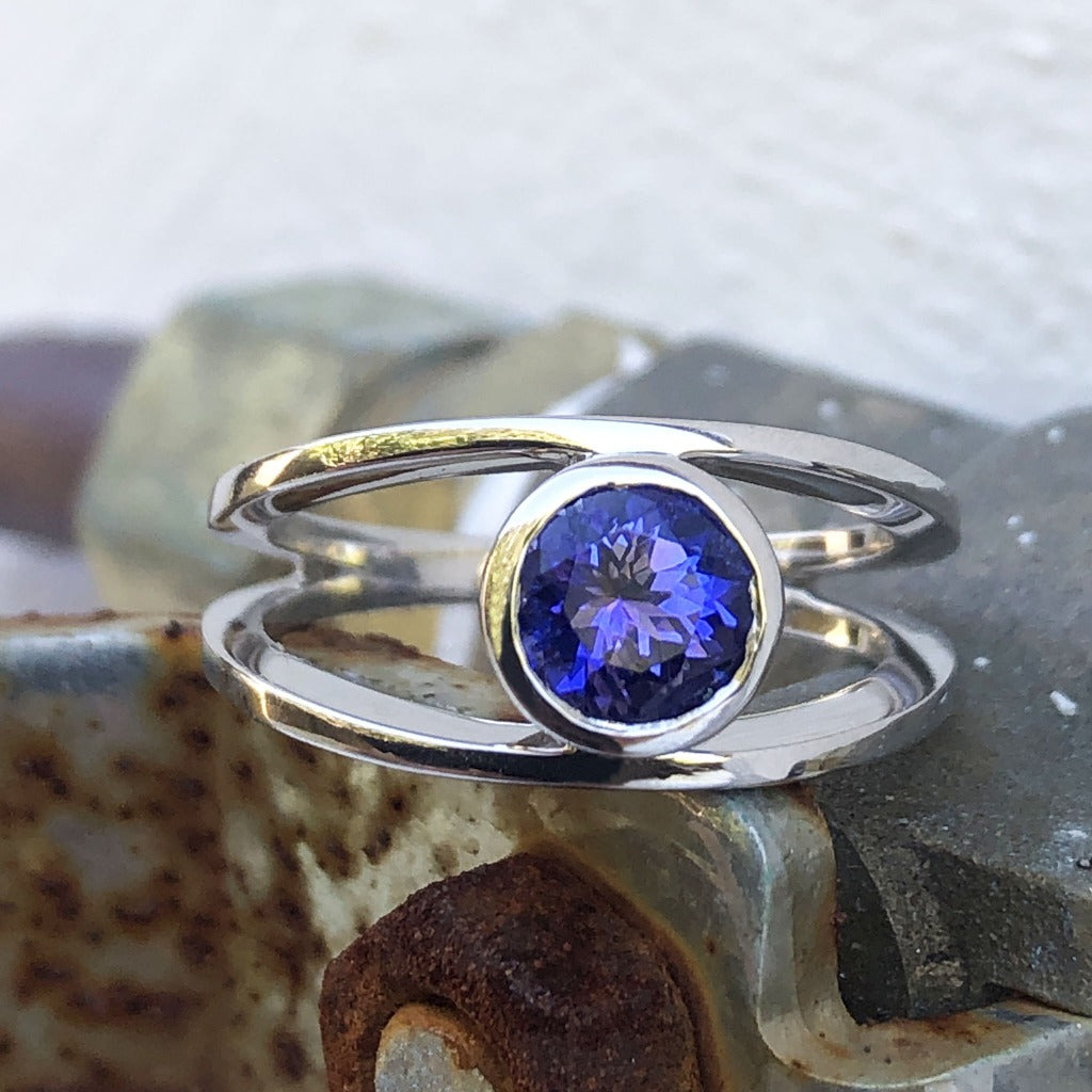 Tube Set Solitaire Tanzanite Set in a White Gold Split Shank Ring