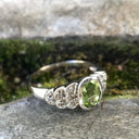 Ornate Oval Cut Peridot Ring with Diamond Step Detail