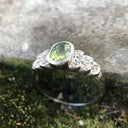 Ornate Oval Cut Peridot Ring with Diamond Step Detail