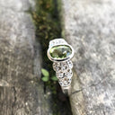 Ornate Oval Cut Peridot Ring with Diamond Step Detail