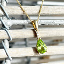 Pear Cut Peridot and Accent Diamond Drop Pendant