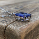 Emerald Cut Tanzanite with Swish Detailed Fixed Bale pendant