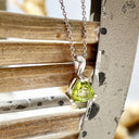Double Claw Trilliant Cut Peridot Pendant