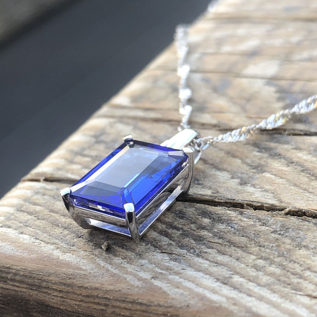 Emerald Cut Tanzanite with Swish Detailed Fixed Bale pendant