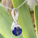 Luxurious Matt White Gold Bow Tanzanite and Diamonds Pendant