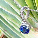 Luxurious Matt White Gold Bow Tanzanite and Diamonds Pendant